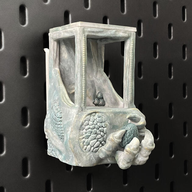 Hand-painted ancient stone dragon claw dice box with open storage drawer, mounted on an IKEA SKÅDIS pegboard for TTRPG setup.