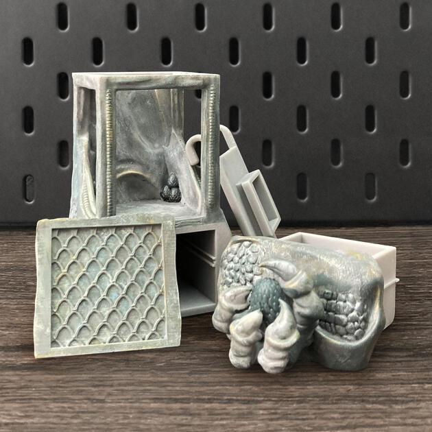 Hand-painted ancient stone dragon claw dice box with open storage drawer, mounted on an IKEA SKÅDIS pegboard for TTRPG setup.