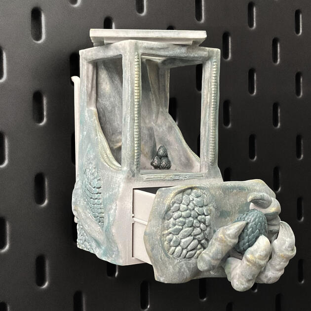 Hand-painted ancient stone dragon claw dice box with open storage drawer, mounted on an IKEA SKÅDIS pegboard for TTRPG setup.