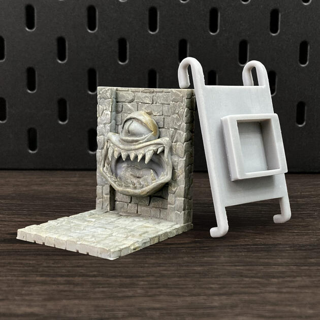 Hand-painted stone texture Mimic dice box, mounted on an IKEA SKÅDIS pegboard as a TTRPG miniature display.