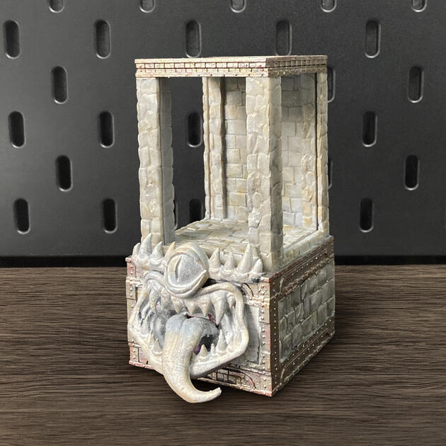 Hand-painted stone texture Mimic dice box with open storage drawer, mounted on an IKEA SKÅDIS pegboard as a TTRPG miniature display.