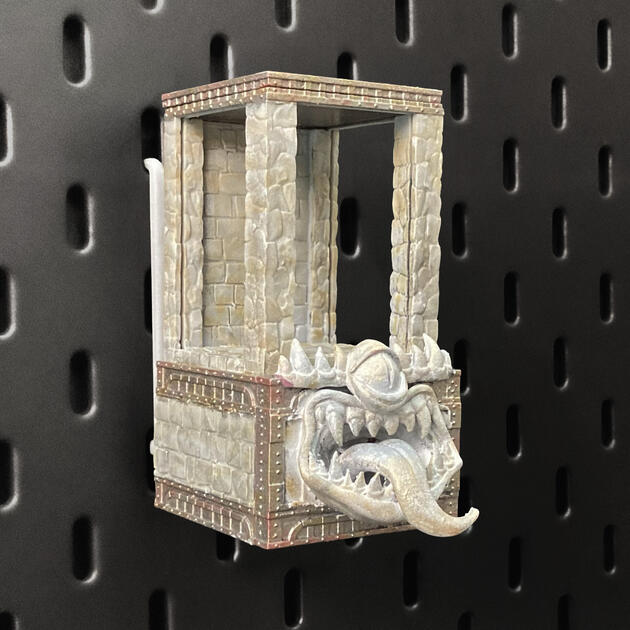 Hand-painted stone texture Mimic dice box with open storage drawer, mounted on an IKEA SKÅDIS pegboard as a TTRPG miniature display.