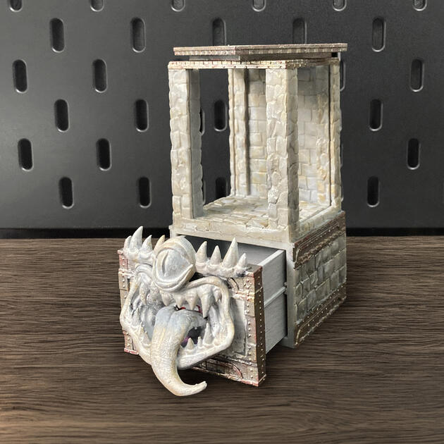 Hand-painted stone texture Mimic dice box with open storage drawer, mounted on an IKEA SKÅDIS pegboard as a TTRPG miniature display.